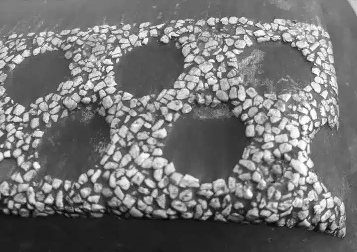 Detailed diagram of ceramic insert blow bars with extended coverage at the strike edge